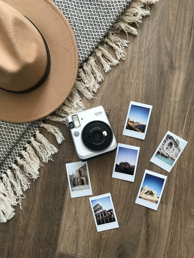 a picture is worth a thousand words, photo with a hat, camera and several polaroids