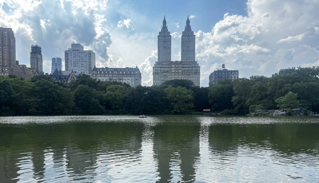 nyc travel tips, view of lake over central park with nyc buildings in background